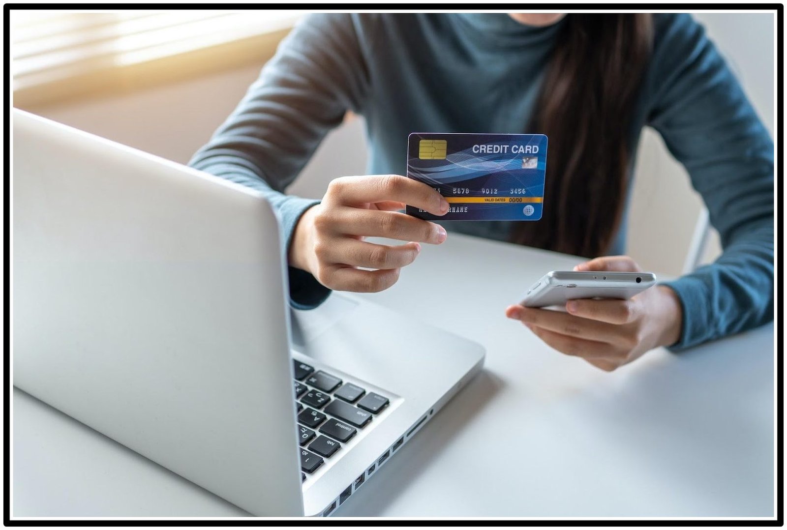 a womam holding a credit card